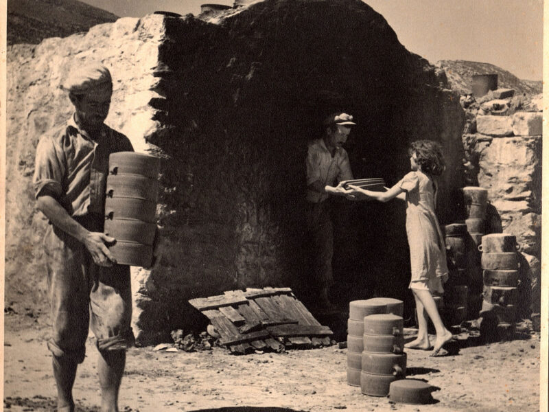 Members of the Lemonis family loading cookware, c. 1960.